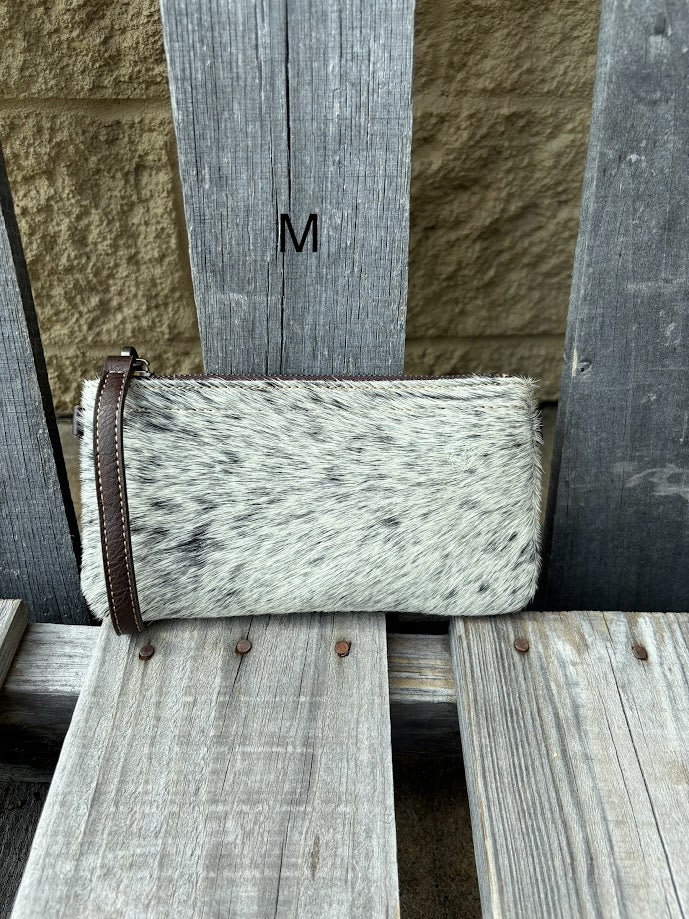 Cowhide wristlet purse in a Coffee Brown solid leather back and a zippered closure. It has a wristlet strap and a removable adjustable shoulder strap. Front View M