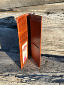 Brown ostrich print leather checkbook wallet with cowhide inlay and Praying Cowboy Concho. Inside view showing multiple card slots, ID window, and checkbook slot. 