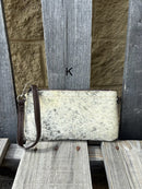 Cowhide wristlet purse in a Coffee Brown solid leather back and a zippered closure. It has a wristlet strap and a removable adjustable shoulder strap. Front View K