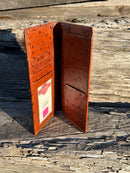 Brown ostrich print leather checkbook wallet with a cowhide inlay featuring a Bull Rider Concho. Inside view showing multiple card slots, ID window, and checkbook slot. 