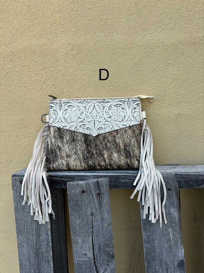 Beige tooled leather and cowhide purse with fringe details and a zippered closure. Front View D
