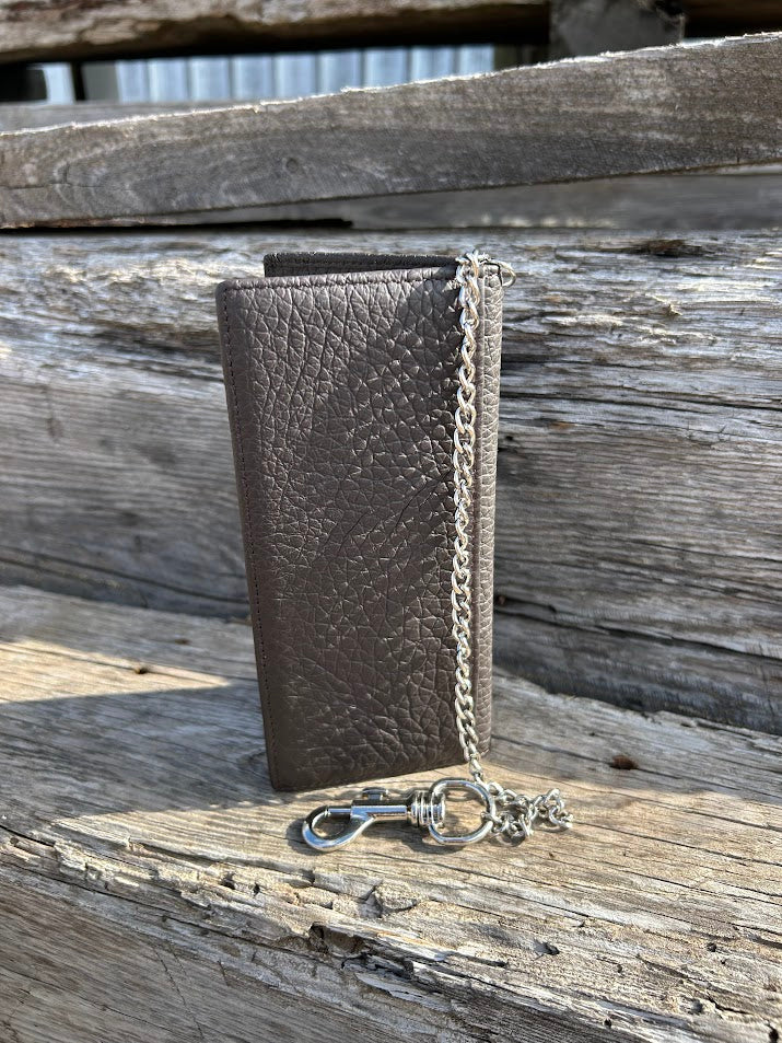 Black pebbled leather tall wallet with silver chain on a swivel. Rear view