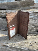 Coffee Brown leather tall wallet with an embossed praying cowboy design on top, and the bottom is basket weave featuring three inlay cowhide crosses. Inside view showing ID window, thirteen card slots, and multiple cash slots. 