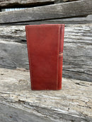 Brown leather tall wallet with embossed Praying Cowboy design on top of a basketweave leather bottom with three cowhide inlay crosses. Rear View