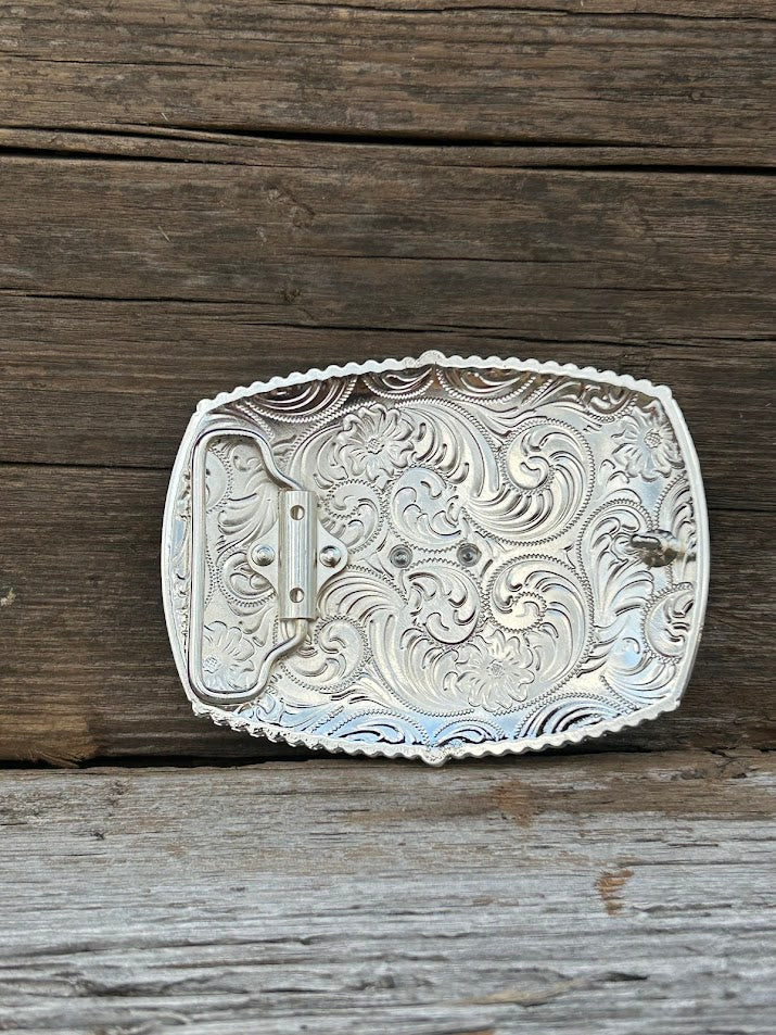 This matte black buckle features a Longhorn design with a intricate Silver border.  Rear View 