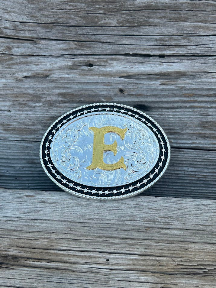 Matte Black and Silver oval shaped belt buckle with Gold initial. Initial E