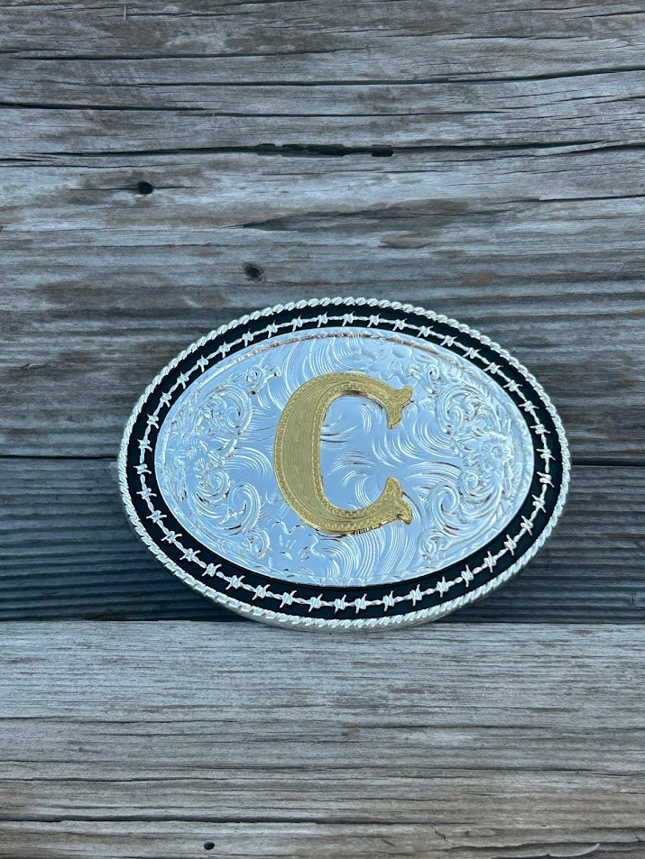 Matte Black and Silver oval shaped belt buckle with Gold initial. Initial C