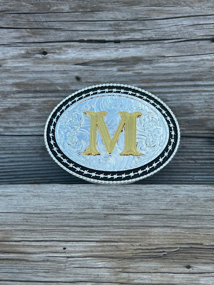 Matte Black and Silver oval shaped belt buckle with Gold initial. Initial M