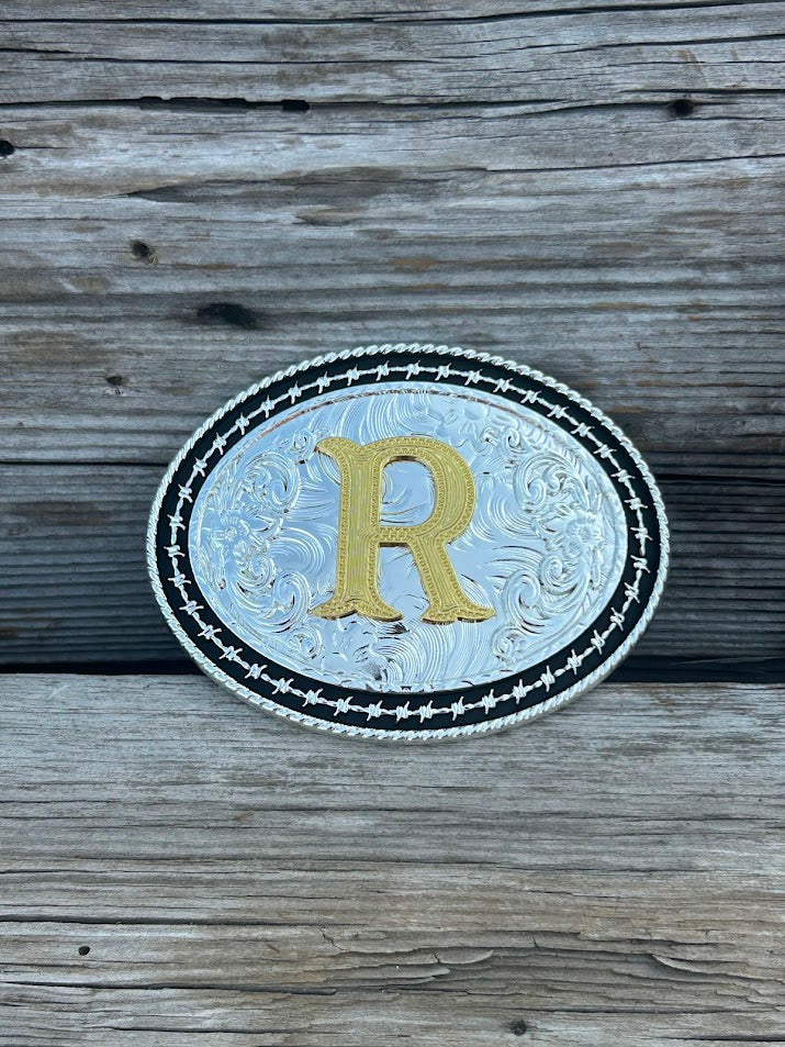 Matte Black and Silver oval shaped belt buckle with Gold initial. Initial R
