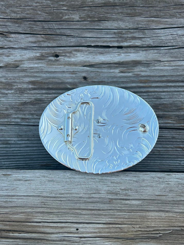Matte Black and Silver oval shaped belt buckle with Gold initial.  Rear View