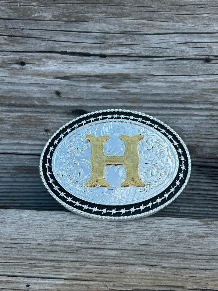 Matte Black and Silver oval shaped belt buckle with Gold initial. Initial H