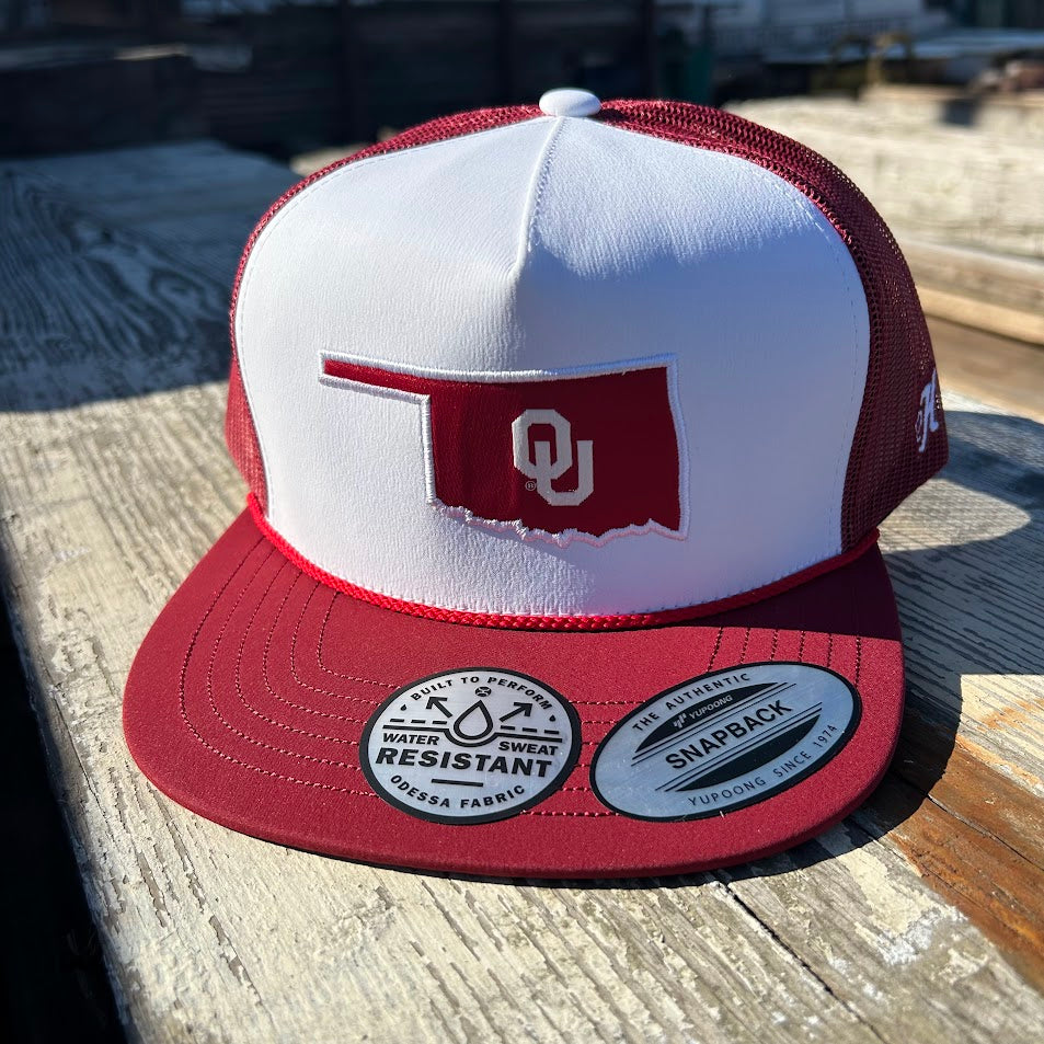 Red and white snapback cap with Oklahoma state outline and OU logo patch. Front View 