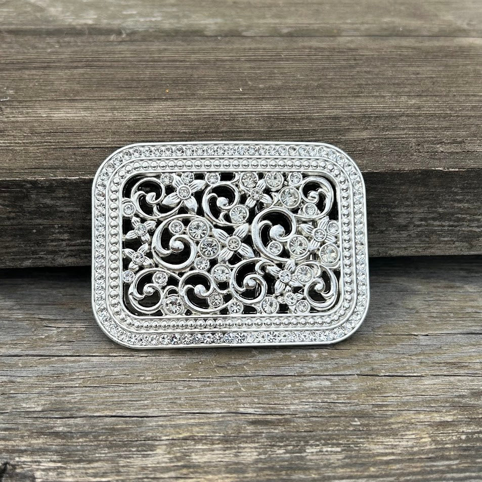 Silver rectangle belt buckle with intricate scrollwork featuring clear rhinestones. Front View