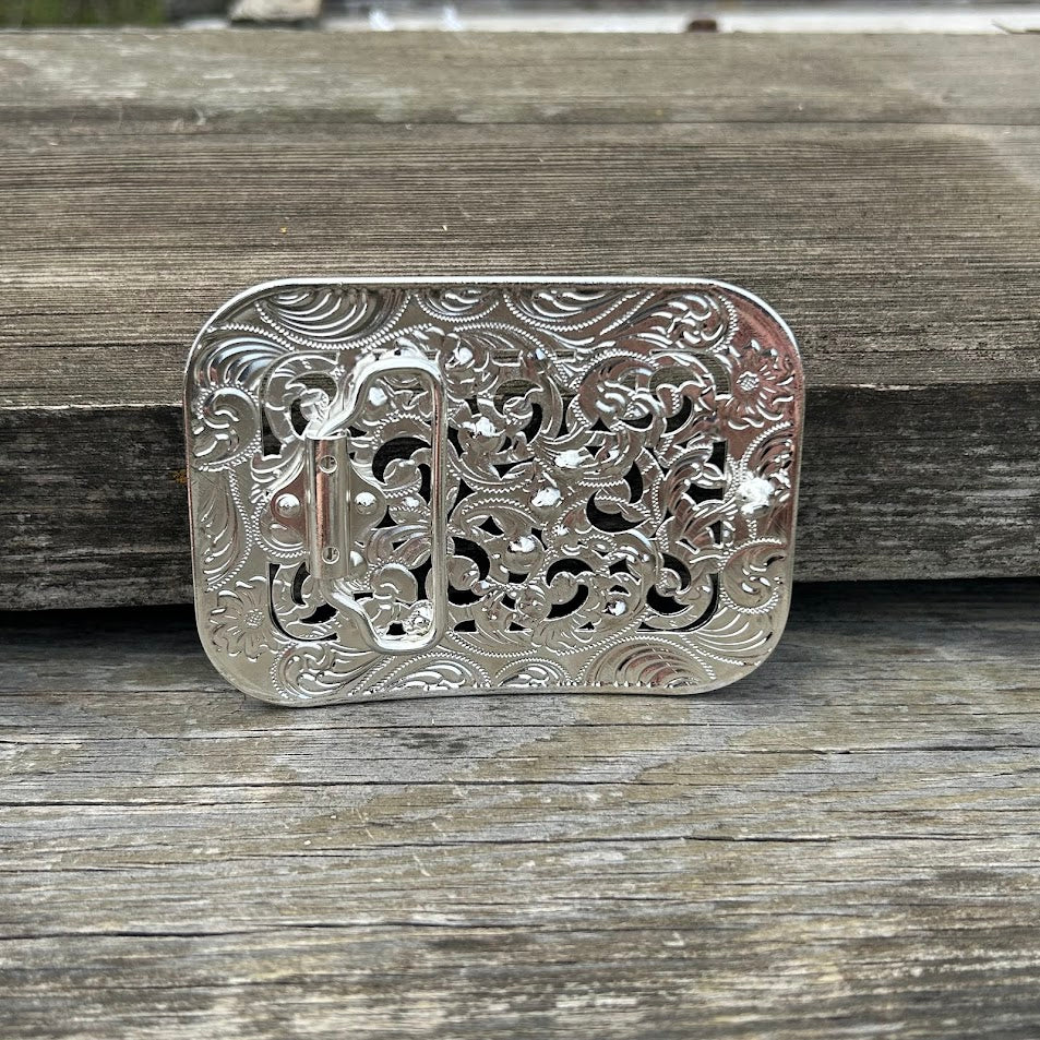Silver rectangle belt buckle with intricate scrollwork featuring clear rhinestones. Rear View
