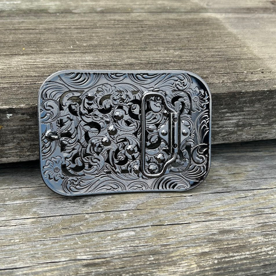 Matte Black belt buckle with floral scrollwork and rhinestones. Rear View