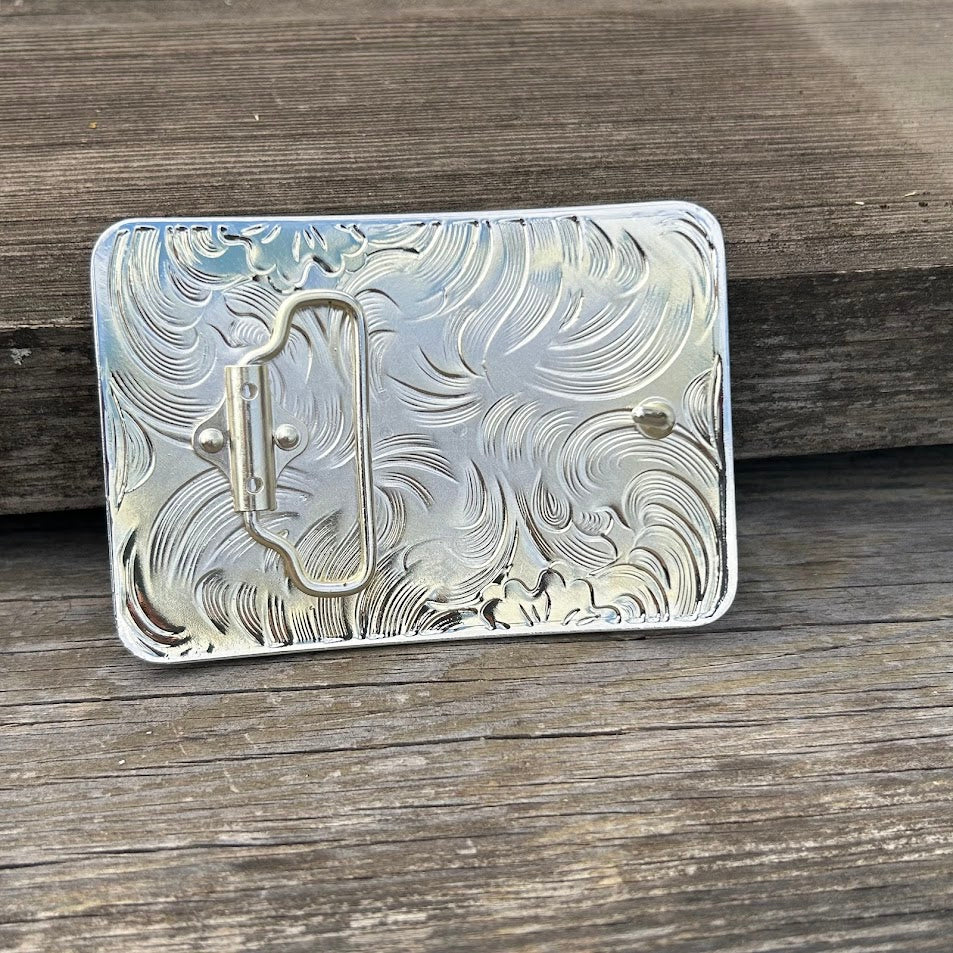 This silver, gold, and black buckle features a Praying Cowboy design on a gold rectangle featuring Black accents and a intricate silver border. Rear View