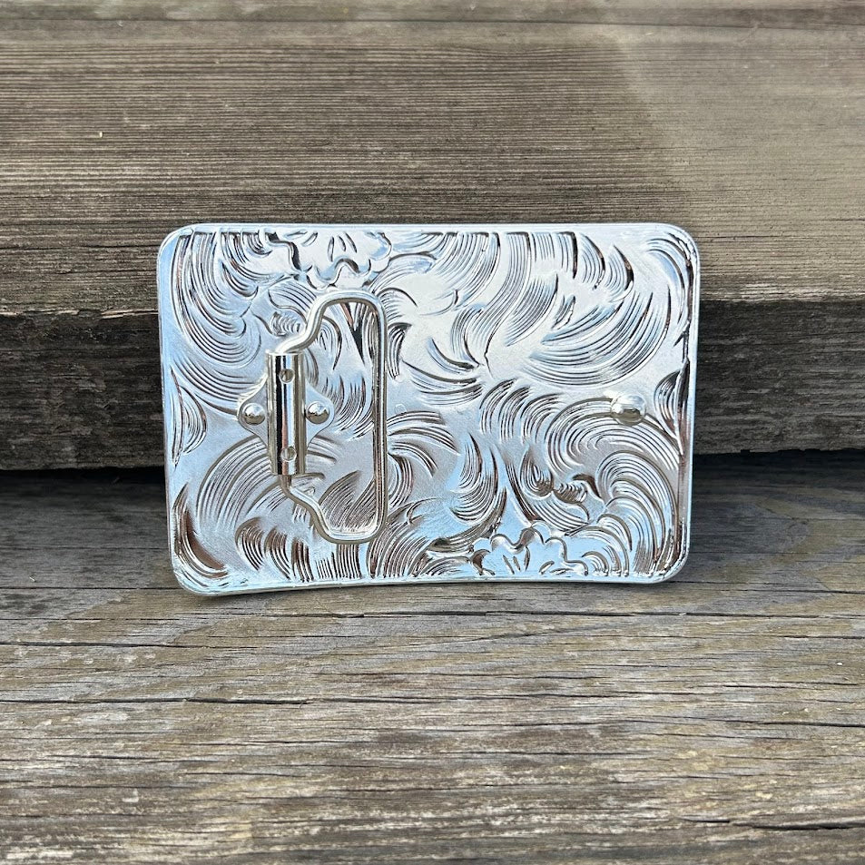This silver and black buckle features a Praying Cowboy design on a Silver rectangle featuring Black accents and a intricate border. Rear View