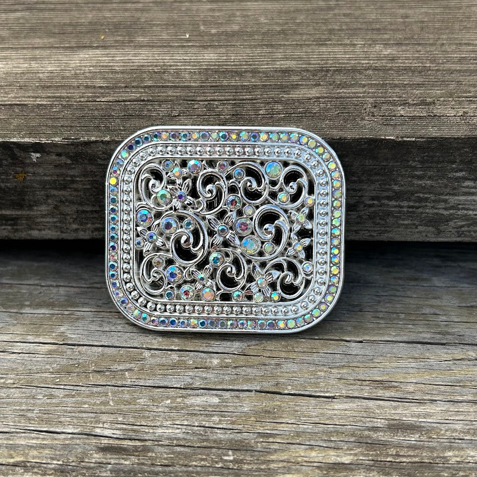Silver western style belt buckle with iridescent rhinestones. Front View 