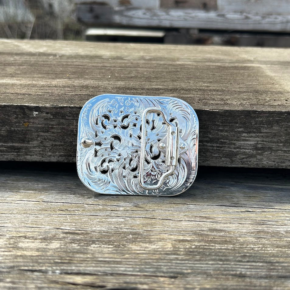 Silver western style belt buckle with iridescent rhinestones. Rear View