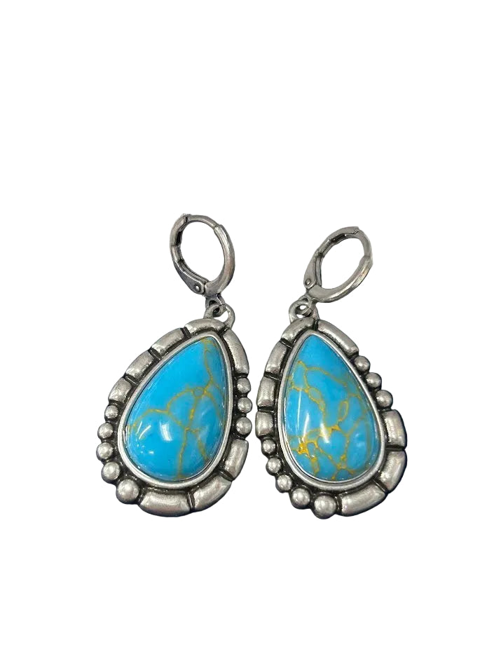 Crafted Turquoise teardrop earrings with silver border and a hinged clasp.  Full frontal view 