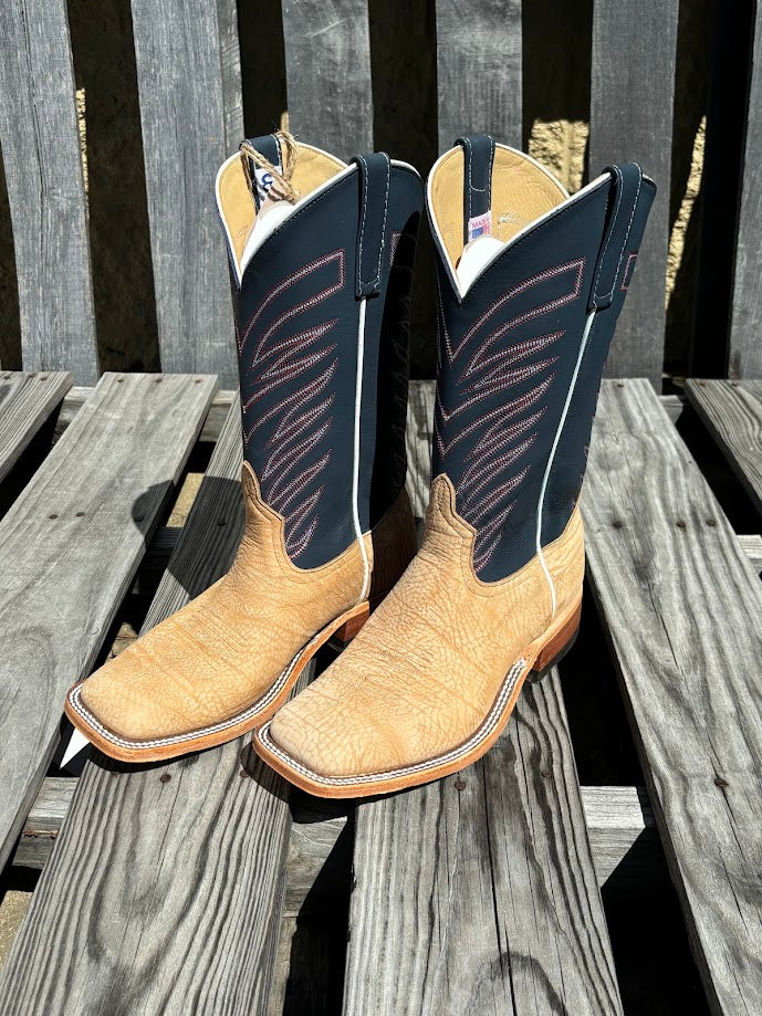 A pair of men's Anderson Bean cowboy boots with tan washed shoulder and a 12" navy upper. Side view featuring white contrast piping. 