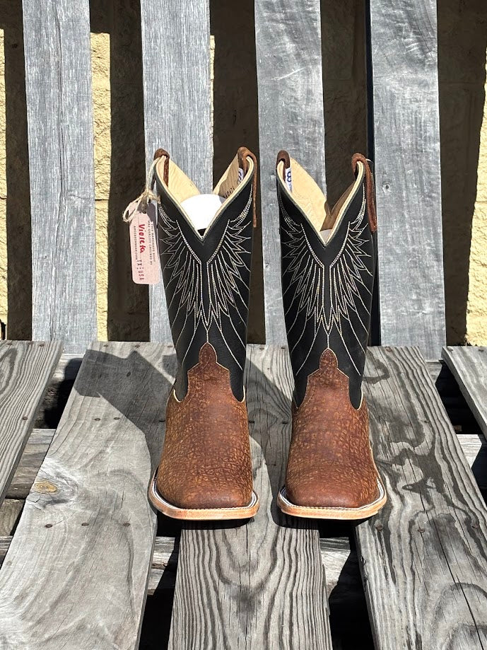 A pair of Men's Anderson Bean 12-inch tan hungry hippo skin boots with black waxy Kansas leather tops.  Front View
