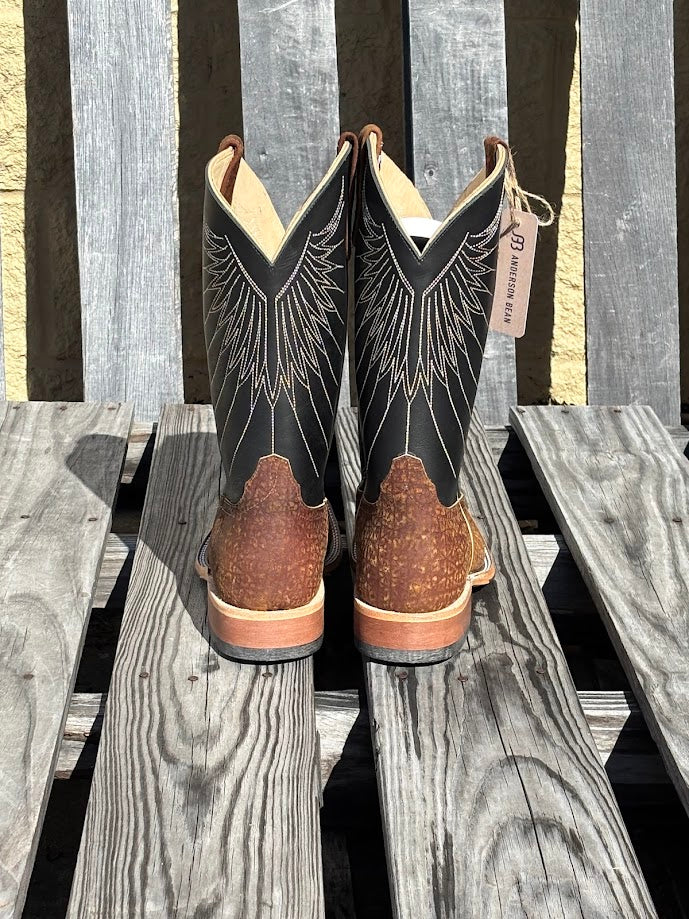 A pair of Anderson Bean 12-inch tan hungry hippo skin boots with black waxy Kansas leather tops.  Rear View