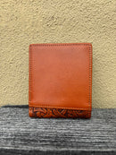 A Light Brown leather bifold wallet with beige inlay design featuring a embossed buck design.  Rear view 