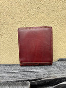 A brown bifold wallet featuring a embossed buck design with brown inlay. Rear view 