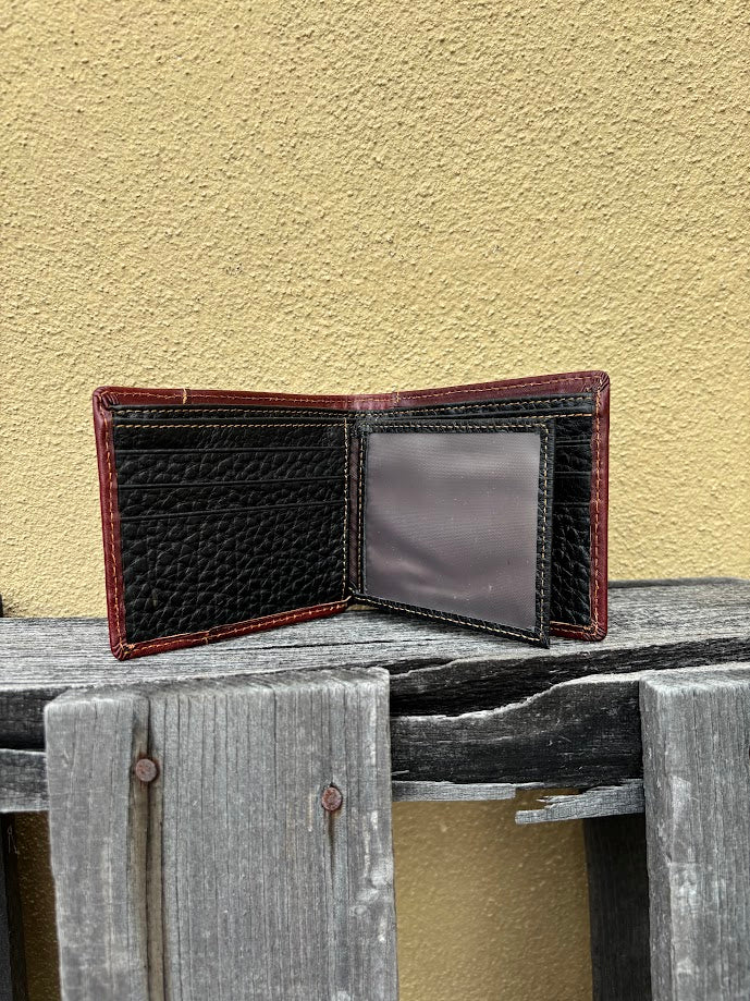 A brown bifold wallet featuring a embossed buck design with brown inlay. Inside view showing multiple card slots and dual ID window. 