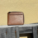This Brown bifold leather wallet features a zipper closure. Front View