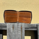 This Brown bifold leather wallet features a zipper closure.  Inside view showing multiple card slots. 