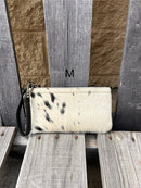 Cowhide wristlet purse in Black leather with a zippered closure. This bag has a wristlet handle or shoulder strap. Front View M