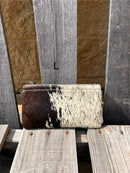 Cowhide wristlet purse in Black leather with a zippered closure. This bag has a wristlet handle or shoulder strap. Front View L