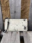 Cowhide wristlet purse in Black leather with a zippered closure. This bag has a wristlet handle or shoulder strap. Front View D