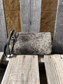 Cowhide wristlet purse in Black leather with a zippered closure. This bag has a wristlet handle or shoulder strap. Front View I
