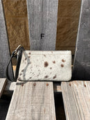 Cowhide wristlet purse in Black leather with a zippered closure. This bag has a wristlet handle or shoulder strap. Front View F