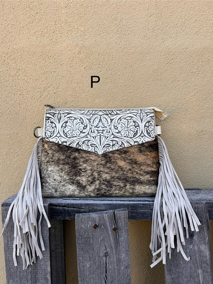 Beige tooled leather and cowhide purse with fringe details and a zippered closure. Front View P