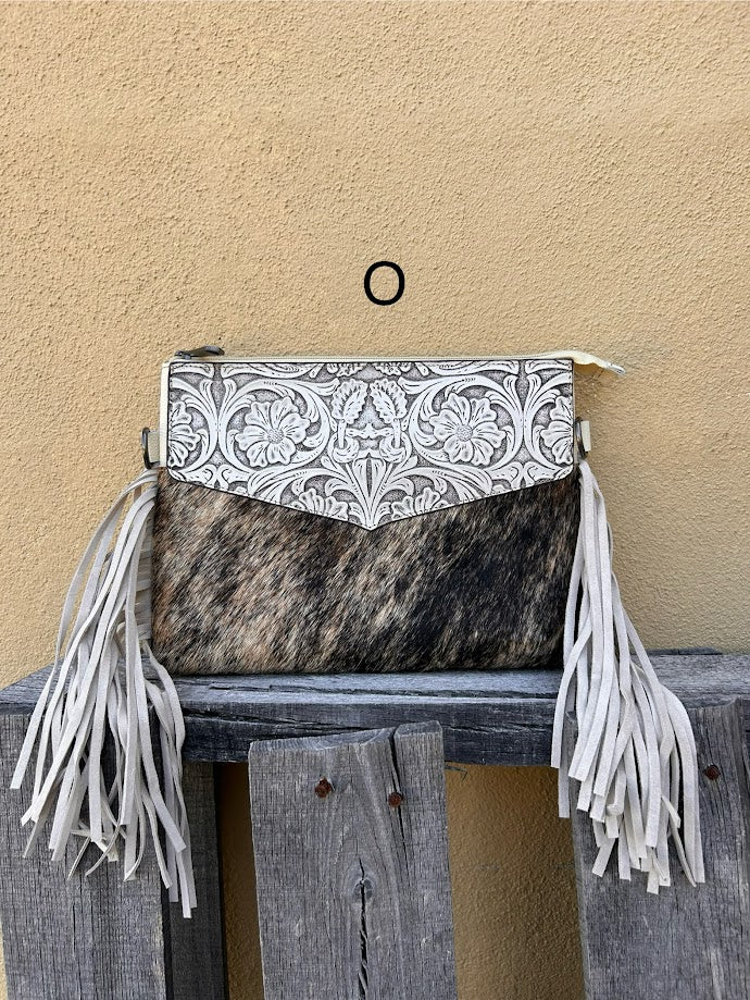 Beige tooled leather and cowhide purse with fringe details and a zippered closure. Front View O