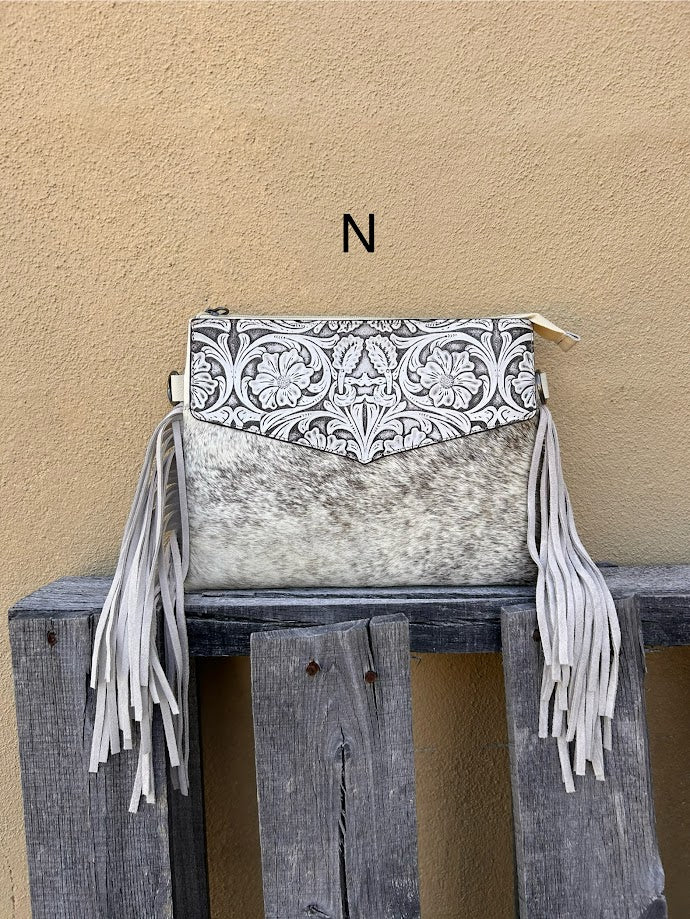 Beige tooled leather and cowhide purse with fringe details and a zippered closure. Front View  N
