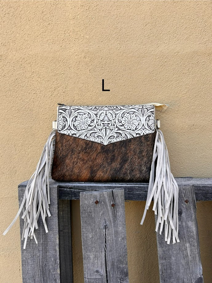 Beige tooled leather and cowhide purse with fringe details and a zippered closure. Front View L