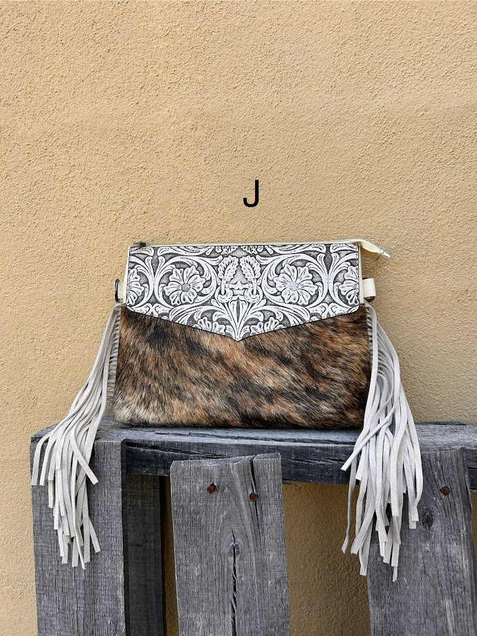 Beige tooled leather and cowhide purse with fringe details and a zippered closure. Front View J