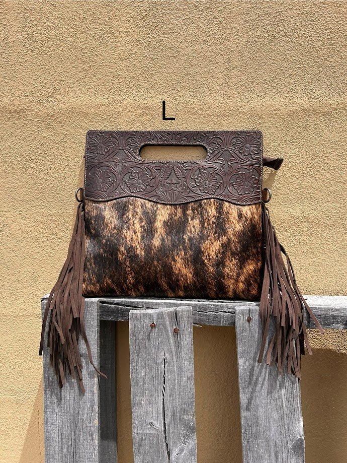 Cowhide and Coffee Brown tooled leather purse with fringe. This bag can be carried by the handle or the removable, adjustable strap. Front View L