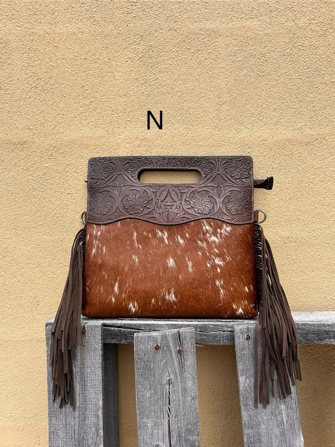 Cowhide and Coffee Brown tooled leather purse with fringe. This bag can be carried by the handle or the removable, adjustable strap. Front View N
