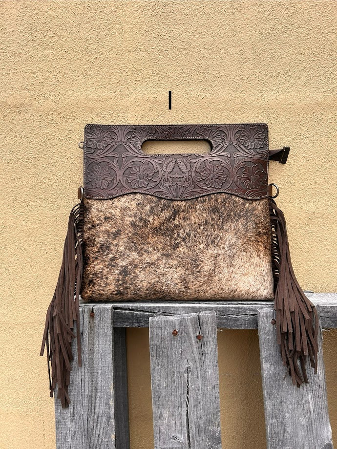 Cowhide and Coffee Brown tooled leather purse with fringe. This bag can be carried by the handle or the removable, adjustable strap. Front View I