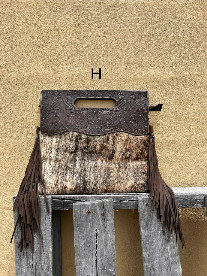 Cowhide and Coffee Brown tooled leather purse with fringe. This bag can be carried by the handle or the removable, adjustable strap. Front View H