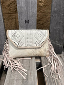 This cowhide and Beige leather bag features fringe sides and can be used as a wristlet or crossbody. It has a geometric print debossed flap with a whipstitch border.  Front View M