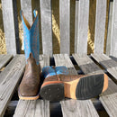Men's Anderson Bean cowboy boots in cognac Cape Safari Buffalo, these boots have a square toe. One boot is lying down to show the hybrid outsole. 