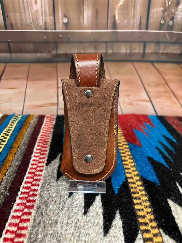 Brown leather knife sheath with a Hair-On cross design.  Rear view showing leather belt loop attachment. 