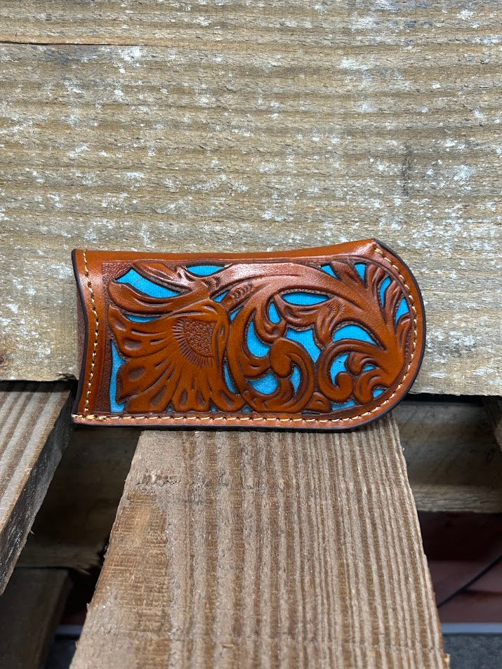 Light brown tooled leather knife sheath with a Turquoise inlay. Front View